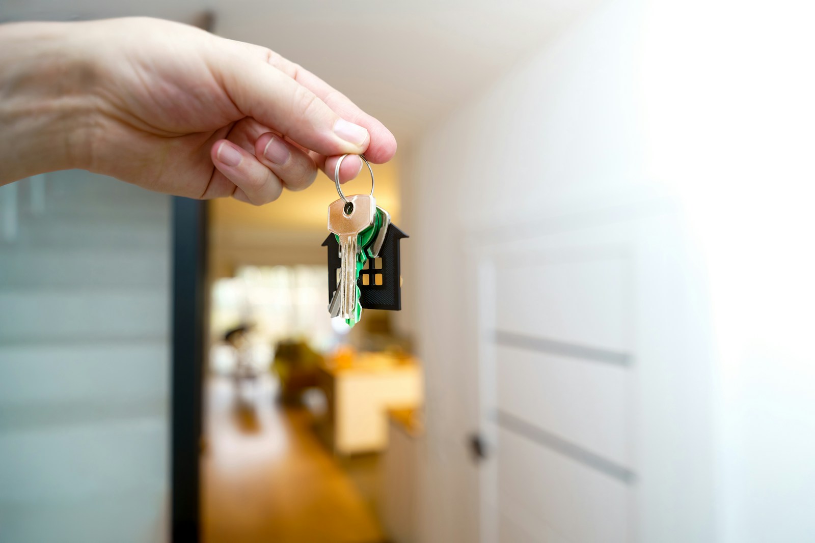 House keys held near a front door